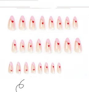 Macro shot of 24pcs pink French almond press-on nails with small red heart patterns
