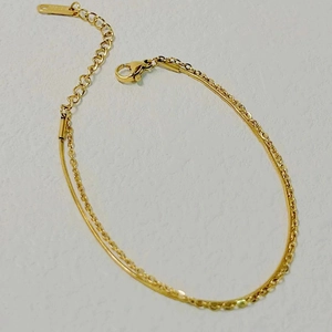 Detail view of 18k gold plated double layer snake and O-link chain bracelet with lobster clasp