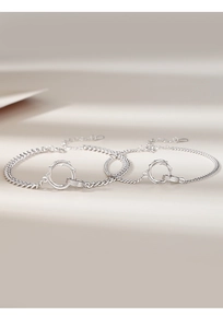 Detail view of two silver Mobius thorn bracelets with elegant circular ring clasp design