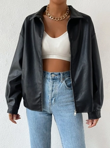 Detail of black faux leather jacket texture with silver hardware and classic lapel collar