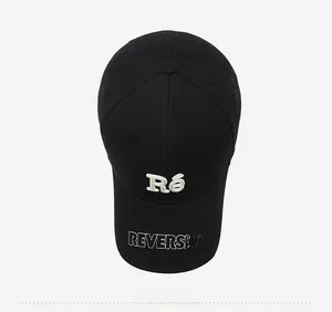 Top view of black cotton baseball cap with detailed white letter embroidery design