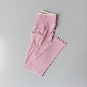 Flat lay of pink seamless yoga pants featuring high waist design and peach butt lifting texture