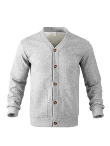Detail of grey V-neck cardigan featuring textured geometric knit and marble buttons