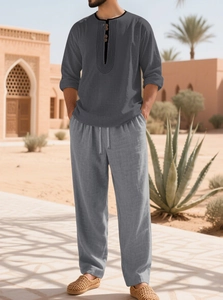 Detailed texture of dark grey cotton linen fabric on a long sleeve Henley shirt set