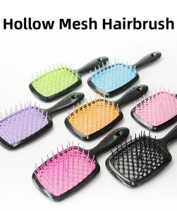 Flat lay of colorful hollow grid hairbrushes with flexible bristles for styling