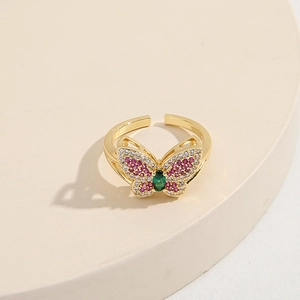 Gold-plated butterfly ring with colorful cubic zirconia on minimalist tray