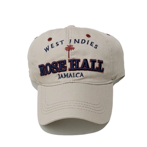Detail shot of West Indies embroidery and red palm tree icon on beige cotton baseball cap