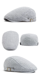Detail view of light grey linen newsboy cap showing metal buckle from multiple angles