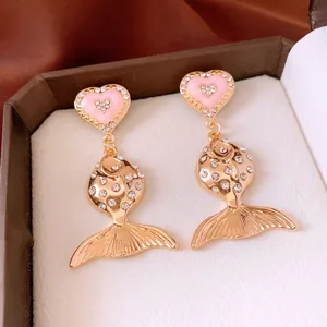 Vintage style gold fish drop earrings with pink enamel hearts and sparkling rhinestones