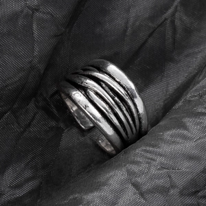 Detailed view of vintage silver oxidized multi-layer adjustable open ring on black fabric