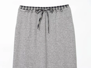 Detail of knit skirt elastic waistband with contrast plaid drawstring and trim