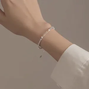 Handcrafted S999 sterling silver irregular nugget bracelet with heart charm on wrist