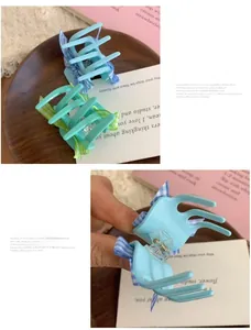 Detail view of sky blue and mint green floral bow hair claws with checkered ribbons