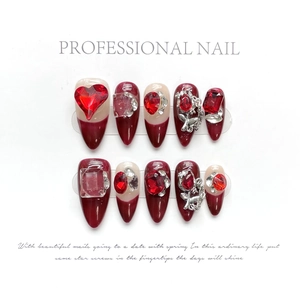 Handmade red teardrop press-on nails with 3D crystal hearts and silver rose charms