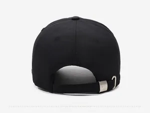 Detail of adjustable black baseball cap rear strap with engraved silver metal buckle