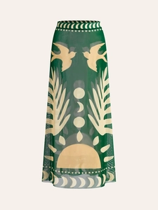 Detail view of mesh skirt with dark green bird and celestial nature patterns