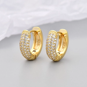 Detail of 925 sterling silver gold plated hoop earrings with micro paved cubic zirconia