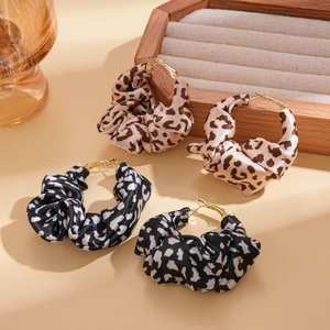 Leopard print fabric hoop earrings with elegant knot design and gold metal clasps