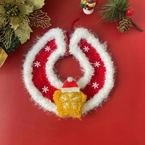 Close-up of red knitted pet Christmas scarf with white snowflake patterns and star