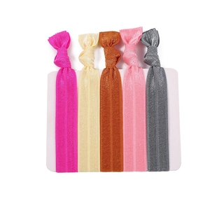 Five assorted colorful elastic knotted hair ties displayed on a white product card