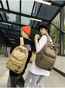 Detailed back view of khaki and army green canvas backpacks with premium leather zipper pulls