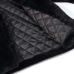 Detailed close-up of black faux fur coat featuring a warm diamond quilted lining