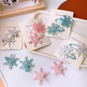 Detail of glitter snowflake hair clips with rhinestones on a decorative display card