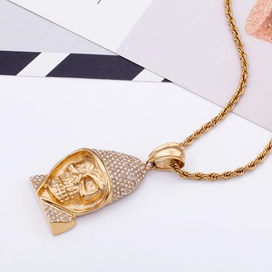 Macro view of golden skull pendant with sparkling crystals and twisted rope chain