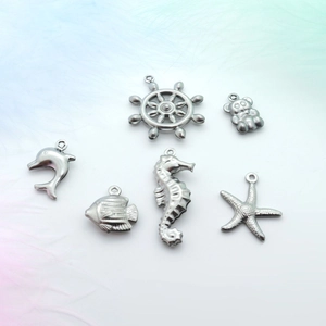 Detailed set of six silver stainless steel marine animal pendants on a colorful feather background