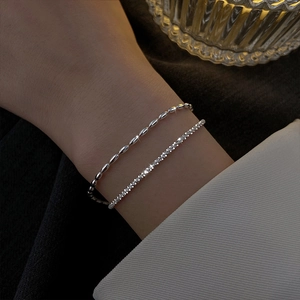 Silver-plated layered bracelet set with shiny beads and sparkling rhinestone tennis chain