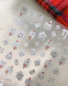 Detailed macro view of 3D embossed winter nail stickers with white snowflake and bear patterns
