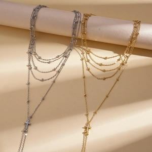 Multi-layer long chain necklace with cross pendant and rhinestones in gold and silver finish
