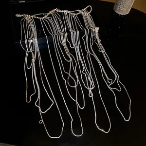 Luxurious silver layered rhinestone body chain with long tassel drape for formal wear