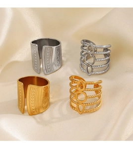 Detailed view of 18K gold and silver plated geometric rings on champagne silk