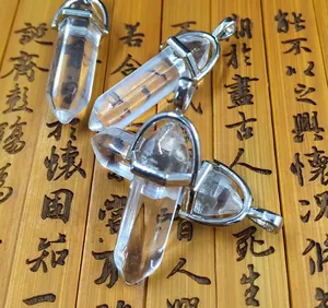 Detailed view of four hexagonal clear crystal point pendants on vintage bamboo scroll