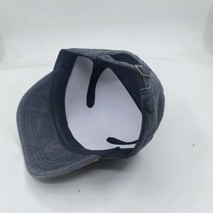 Detail view of washed dark grey cadet cap showing adjustable metal buckle and distressed fabric