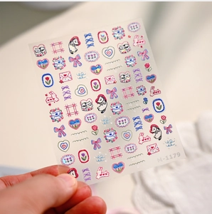 Detail of M-1179 embossed nail stickers featuring cute cartoon cats and tulip patterns