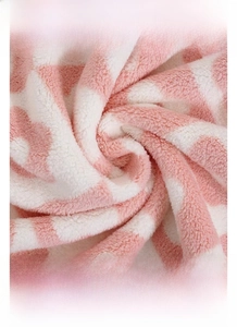 Macro shot of high-density pink and white checkered coral fleece towel fabric texture