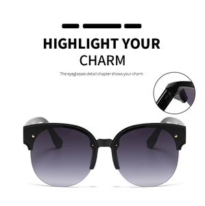 Detail view of round cat-eye semi-rimless sunglasses with metal rivets and gradient lenses