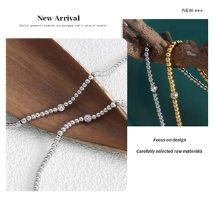 Detailed view of beaded titanium steel bracelet with a sparkling zircon stone pendant
