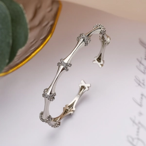 Silver bamboo-joint open bangle with zircon inlay shown at a 45-degree angle