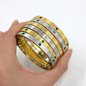 Gold and silver stainless steel bangles with fish scale texture and small gemstones