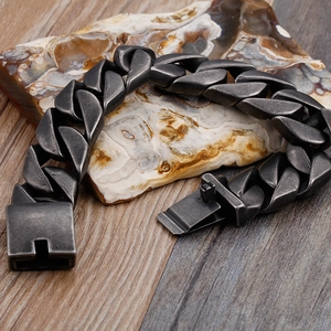 Close-up of 20mm vintage Cuban link bracelet in silver steel on natural stone background
