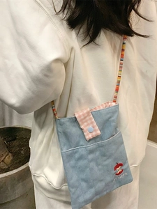 Light blue denim crossbody bag with pink plaid flap and red apple embroidery