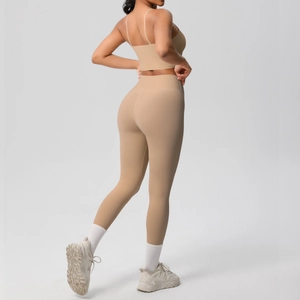 Rear view of light brown yoga set featuring thin strap sports bra and high-waisted leggings