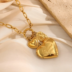 Detailed close-up of 18K gold heart necklace with I Love You engraving and pearl charm