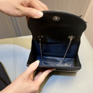 Sparkling black evening clutch with rhinestone accents and silver chain strap shown open