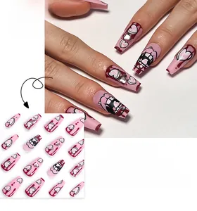 Pink heart press-on nails featuring long coffin shape with rhinestones and y2k graffiti