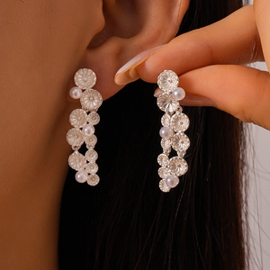 Silver metal floral dangle earrings with white pearls for women in retro vintage style