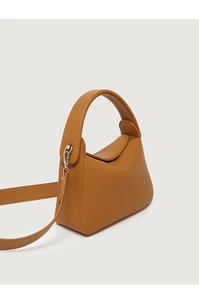 Detail of brown litchi pattern leather handbag with silver hardware and curved handle
